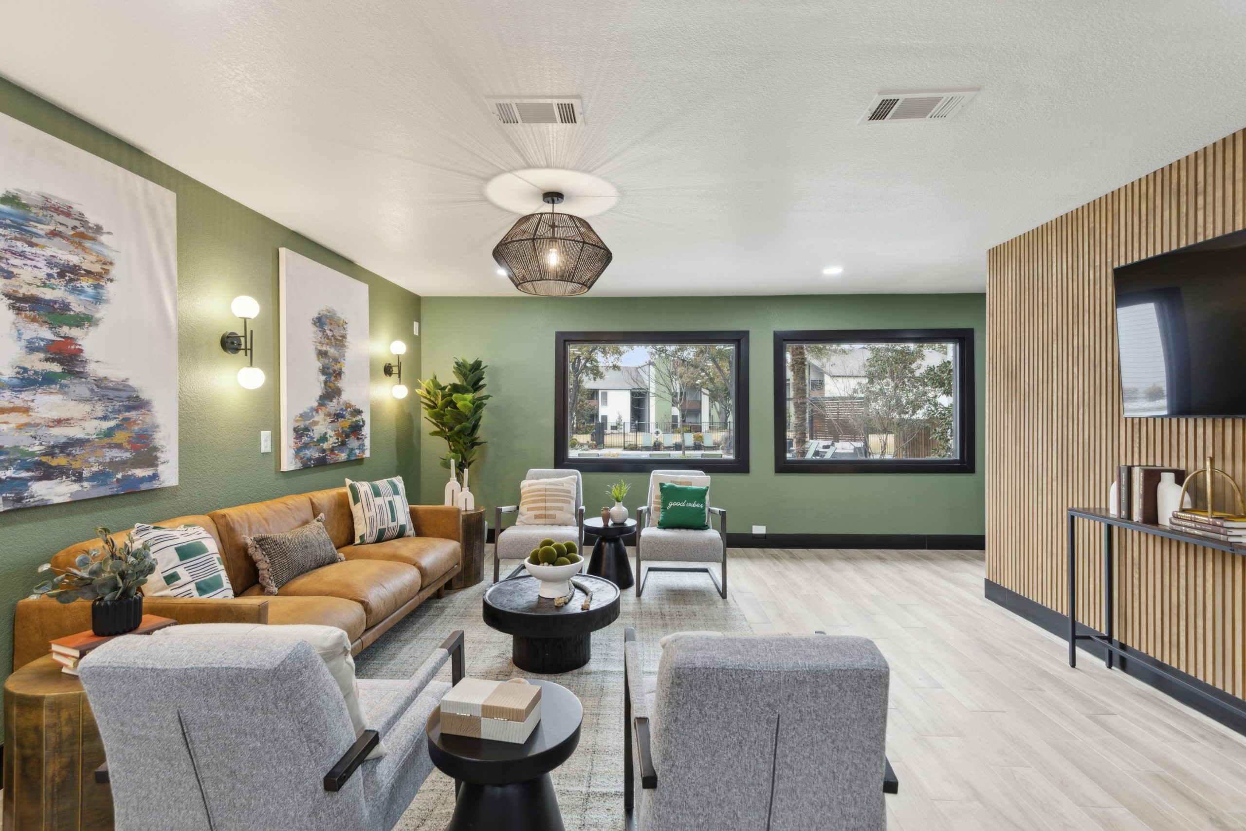 the living room has a green couch and a television at The Reid Apartments