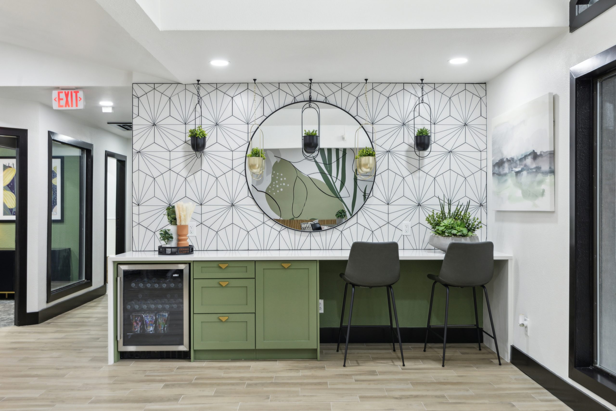 a kitchen with green cabinets and a mirror at The Reid Apartments